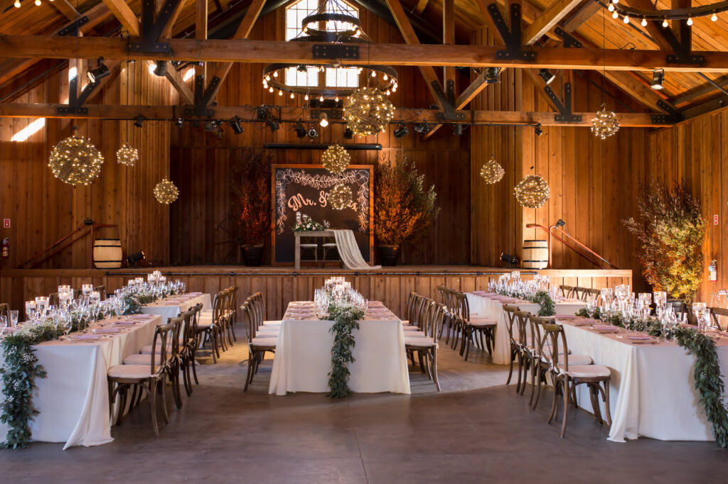 wedding reception table set up in barn